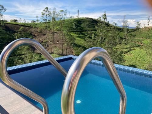 a resort plunge pool with a view of a mountain at Harrington Heritage in Hatton