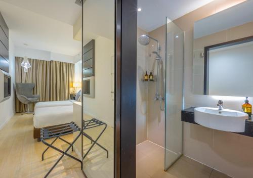 a bathroom with a sink and a shower with a sink at Greystone Centrestage PJ in Petaling Jaya