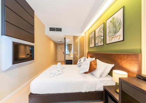 a bedroom with a large bed with a television at Greystone Centrestage PJ in Petaling Jaya