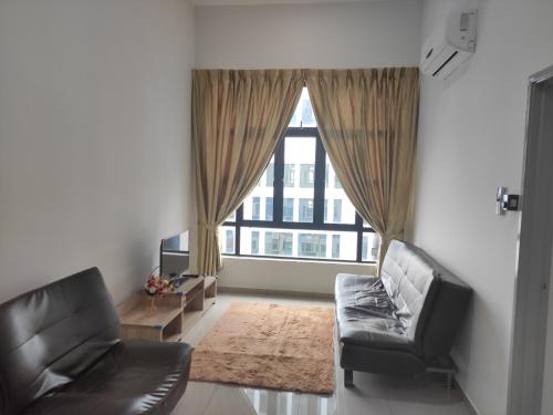 a living room with a couch and a large window at 2Bedroom 5 Mins to MidValley 10 Mins to CIQ in Johor Bahru