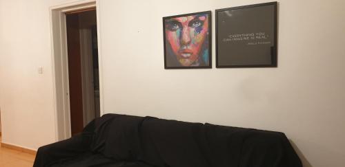 a living room with a couch and a picture on the wall at LINA'S HOME & POOL - Breakbooking CY in Laxia