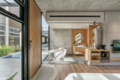 a bathroom with a tub and a sink at Deer Chaser Hotel in Yuchi