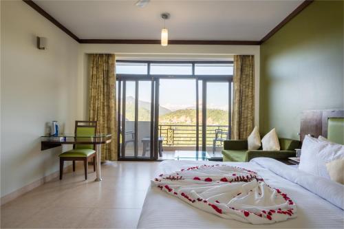 a bedroom with a large bed and a balcony at Revathi Resorts in Jajal