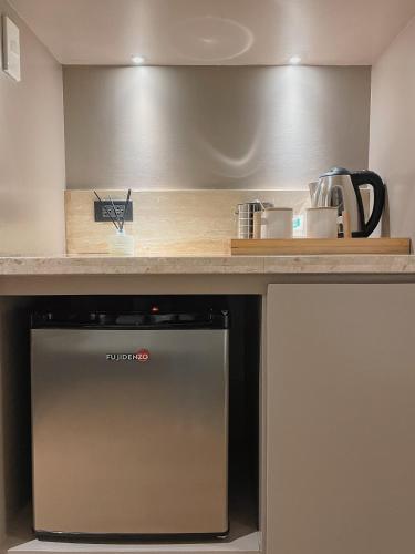 a kitchen with a counter top with a dishwasher at Gunita Villas in Santo Tomas