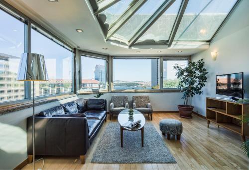 a living room with a large glass ceiling at Taxim Suites Residences Istanbul in Istanbul