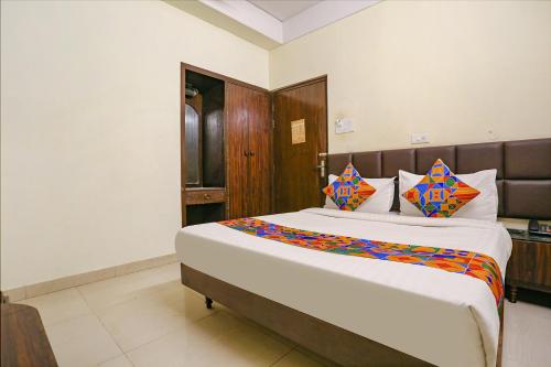 a bedroom with a large bed in a room at FabExpress Kanha Classic in Kānpur