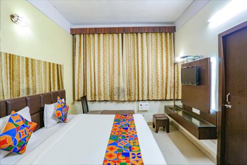 a hotel room with a bed and a television at FabExpress Kanha Classic in Kānpur