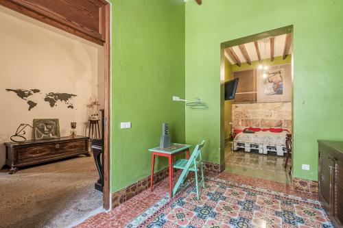 a room with a room with a bed and a table at Townhouse Can Miquel in Sa Pobla