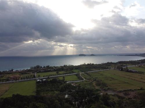 an aerial view of the ocean with a cloudy sky at 三仙台日出民宿 in Chenggong