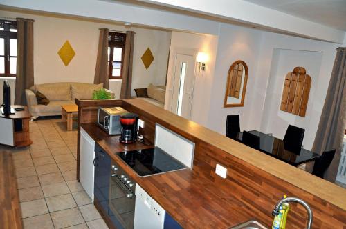 a kitchen with a counter top and a living room at Ferienwohnung Mörlenbach Altstadt in Mörlenbach