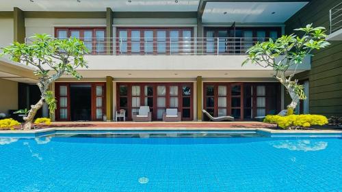 a large swimming pool in front of a building at Merbau Luxurious Villa Senggigi by The Lavana - 5 Bedroom Villa in Mataram