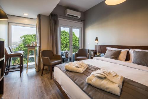 a hotel room with a large bed with two towels on it at Taxim Suites Residences Istanbul in Istanbul