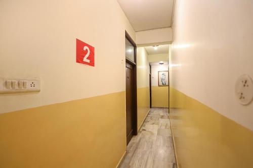 a hallway with a sign on the wall at FabHotel Ashoka Inn in Kānpur