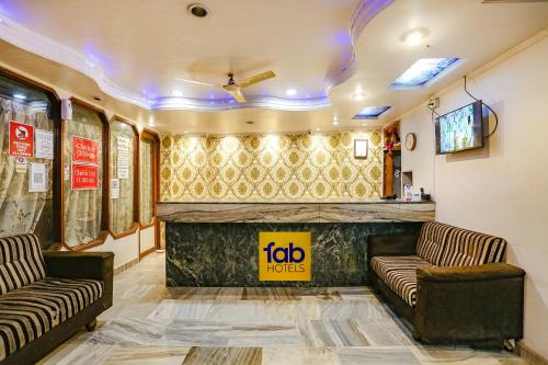 a waiting room with two couches and a fireplace at FabHotel Ashoka Inn in Kānpur