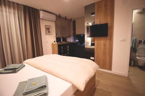 a hotel room with a bed and a television at TOP Room in Šabac