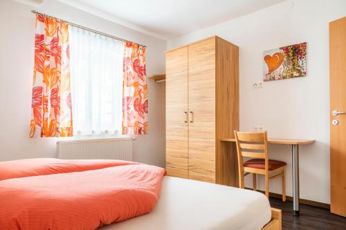 HintergöriachにあるApartment Schlickenhofのベッドルーム1室(ベッド1台、デスク、椅子付)