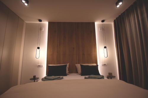 a bedroom with a large white bed with two pillows at TOP Room in Šabac
