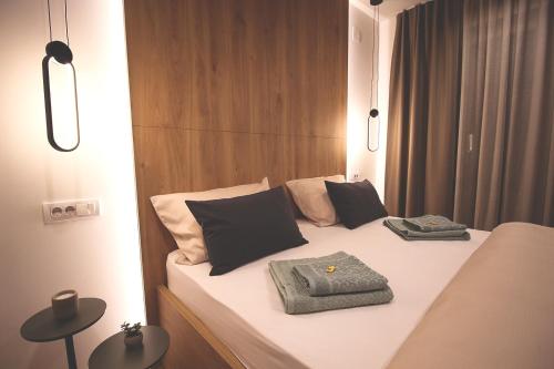 a bed with black and white pillows on it at TOP Room in Šabac
