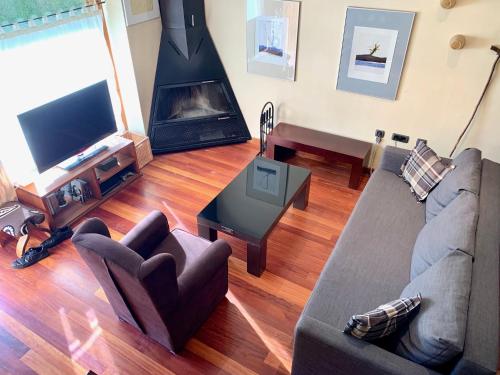a living room with a couch and a fireplace at Casa Riu in Riu de Cerdanya