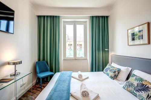 a bedroom with a bed and a desk and a window at All Comfort Astoria Palace in Rome