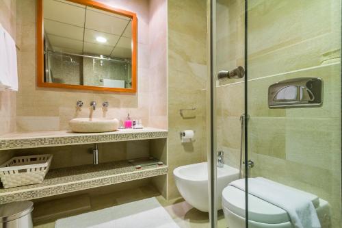 a bathroom with a toilet and a sink and a shower at Maison Privee - Stunning Apartment with Dubai Marina View in Dubai