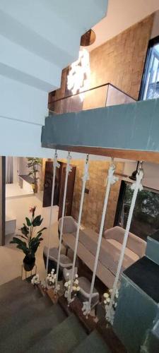 a room with a porch swing with chairs and a plant at RK island view villa in Dabolim