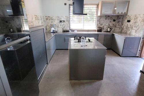 a large kitchen with a island in the middle at RK island view villa in Dabolim