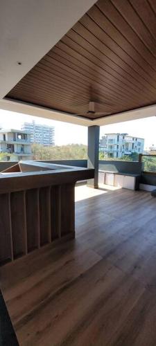 a room with a wooden floor and a wooden ceiling at RK island view villa in Dabolim
