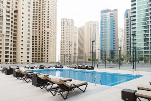 a pool on the roof of a building with buildings at Boutique Living - Marina Wharf in Dubai