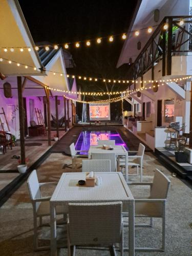 a swimming pool with tables and chairs and lights at Katara Gili, Boutique Rooms and Bungalows in Gili Trawangan