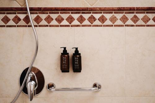 two shampoo bottles on the wall of a shower at Gut Stiluppe - 4 Sterne Superior Good Life Hotel in Mayrhofen