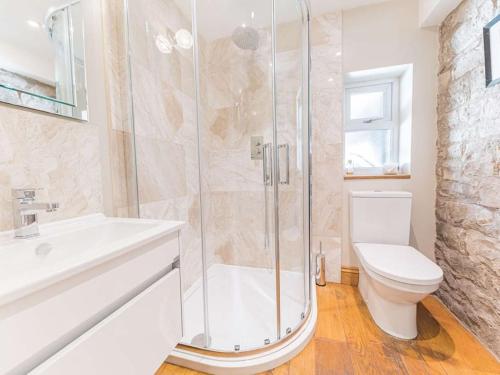 a bathroom with a shower and a toilet and a sink at Southfield is a spacious period five bed, four bath with parking in Kendal