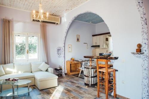 a living room with a white couch and a table at Villa Christa in Arillas