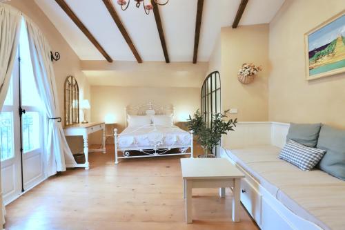 a living room with a bed and a couch at Moon River Village in Ban Bu Khanun