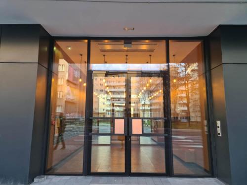 an entrance to an office building with glass doors at Copper Apartment Free Parking in Wrocław