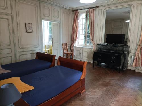 a living room with two beds and a piano at Manoir de Bolbec in Bolbec