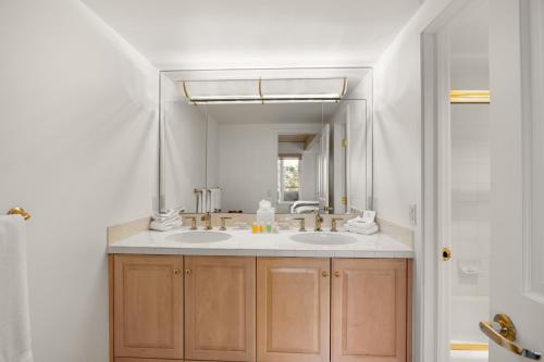 a bathroom with two sinks and a large mirror at Standard Three Bedroom - Aspen Alps #406 in Aspen