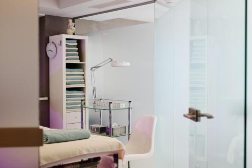 a hospital room with a chair and a lamp at Gut Stiluppe - 4 Sterne Superior Good Life Hotel in Mayrhofen
