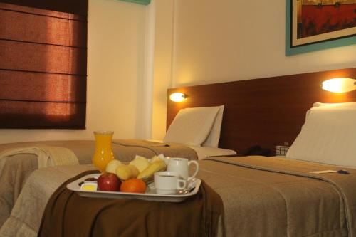 a tray of fruit on a table in a hotel room at Hotel Vila Santa in Lima