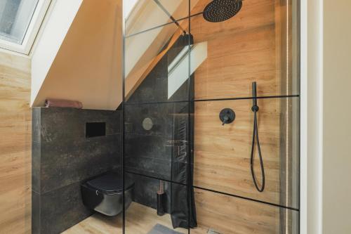 a shower in a bathroom with a glass door at Przepiękny apartament ORANGE z widokiem na Skrzyczne - Sun&Sport in Szczyrk