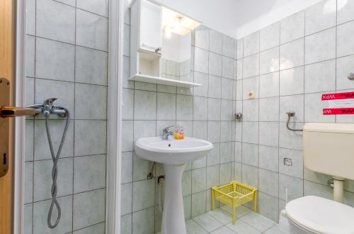 Apartment Luana A2 في فاجانا: حمام مع حوض ومرحاض