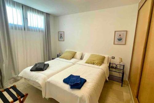 En eller flere senge i et værelse på Corralejo Apartment