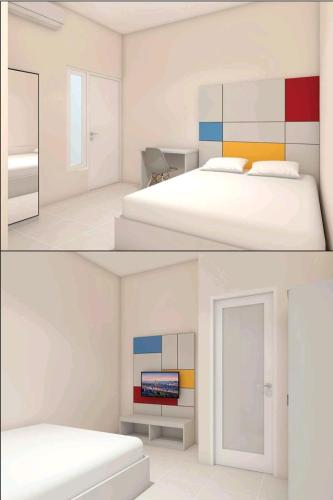 a white bedroom with a bed and a tv at Ndalem Kraton Hotel in Sidoarjo