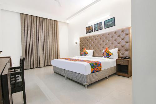 a hotel room with a bed and a window at FabHotel Radiant Inn DLF Phase 3 in Gurgaon