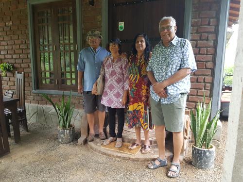 a group of people standing in front of a house at Ceylon Resort in Wilpattu