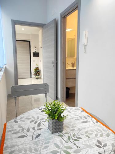 a bedroom with a bed with a potted plant on it at Apartment NAPOLI MARADONA in Naples