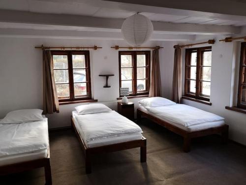 two beds in a room with two windows at Golden View Villa - Great place for vacations in Przesieka