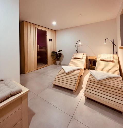a room with three beds and a table at Our Forest House in Tržič