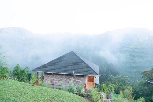 a house on the side of a hill at Gorilla Leisure Lodge in Kisoro