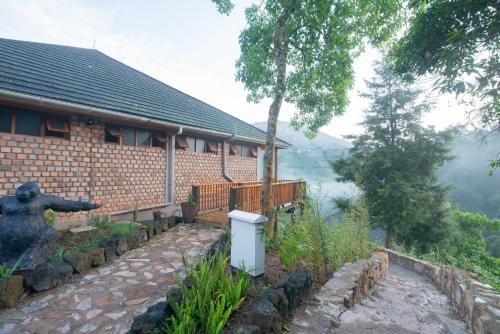 a house with a statue of a bear in front of it at Gorilla Leisure Lodge in Kisoro